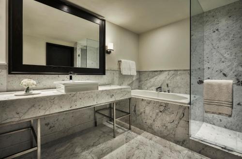 a bathroom with a sink and a tub and a mirror at Four Seasons Hotel Mexico City in Mexico City