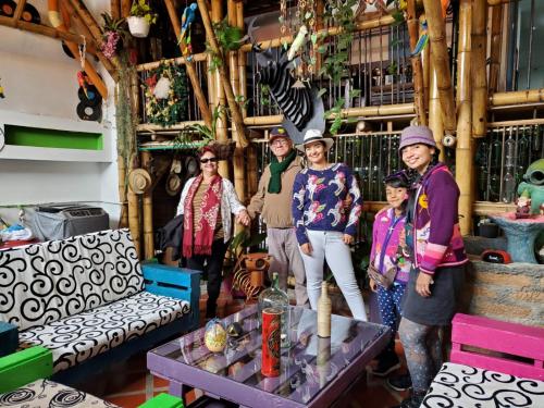 a group of people standing in a store room at Hostel Camelot Salento in Salento