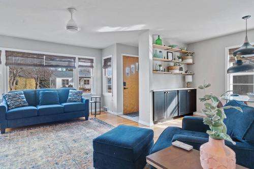 a living room with two blue couches and a table at Walk to Parks Pet Friendly Top Neighborhood in Rapid City