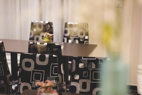 a row of chairs with a table in a room at Zappion Hotel in Athens