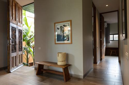 a hallway with a bench and a picture on the wall at El Callejón Hotel Boutique in Oaxaca City