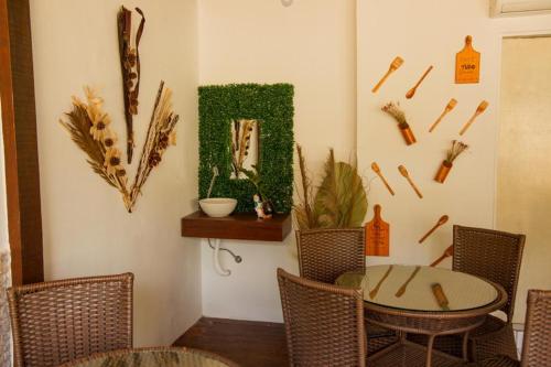 a dining room with a table and chairs and a mirror at Pousada da Leide in Fernando de Noronha