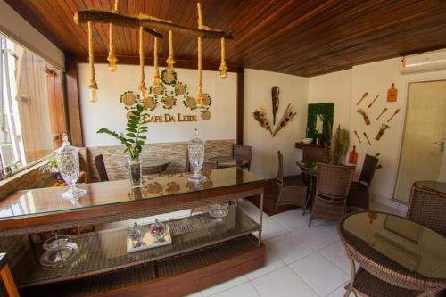 a dining room with a table and chairs and a chandelier at Pousada da Leide in Fernando de Noronha