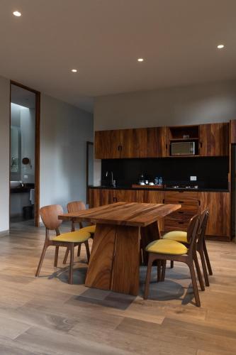a dining room with a wooden table and chairs at El Callejón Hotel Boutique in Oaxaca City