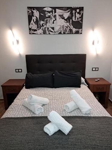 a bedroom with a bed with two towels on it at Apartamento Eursu centro con piscina in Málaga