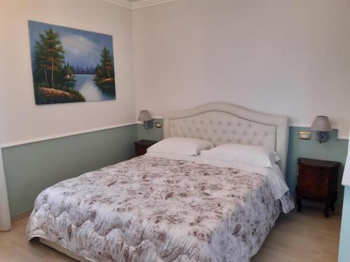 a bedroom with a bed and a painting on the wall at B&B Domus Aurea 20 in San Giovanni Teatino