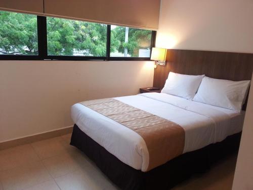 Ένα ή περισσότερα κρεβάτια σε δωμάτιο στο Buenavista Place Hotel