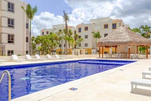 a swimming pool with chairs and a building at Cozy Tulum Oasis: 2-Bedroom w/ Pool in Tulum