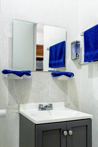 a bathroom with a sink and a mirror at Cozy Tulum Oasis: 2-Bedroom w/ Pool in Tulum