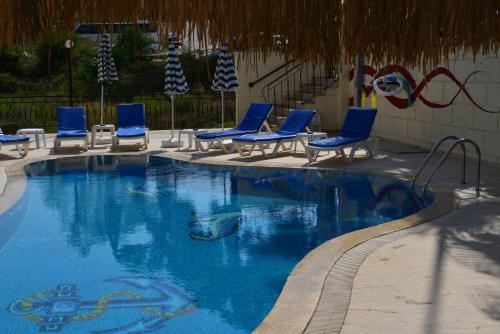 a swimming pool with blue lounge chairs and a swimming pool at Side Boutique Hotel in Side