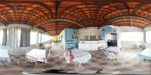 a room with white tables and chairs in a room at Pousada Porto Seguro in Porto De Galinhas