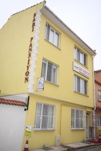 a yellow building with a sign on it at Sari Pension in Edirne