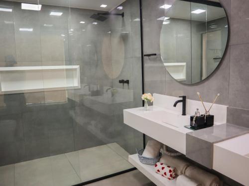 a bathroom with a sink and a mirror at Pousada Gata Russa in Saco do Ceu