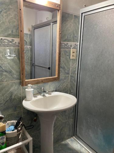 a bathroom with a sink and a shower at Las Margaritas in La Coronilla
