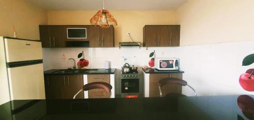 a kitchen with wooden cabinets and a counter top at Departamento Shejiná in Tarija