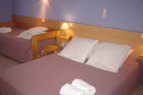 
A bed or beds in a room at Le Gambetta
