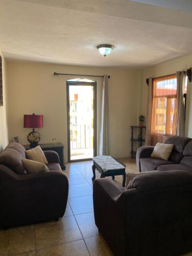 a living room with two couches and a table at Apartamento #3 Portal de Occidente in Quetzaltenango