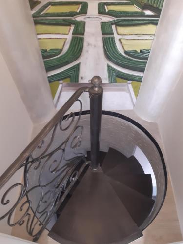 a spiral staircase with a stained glass ceiling at B&B Domus Aurea 20 in San Giovanni Teatino