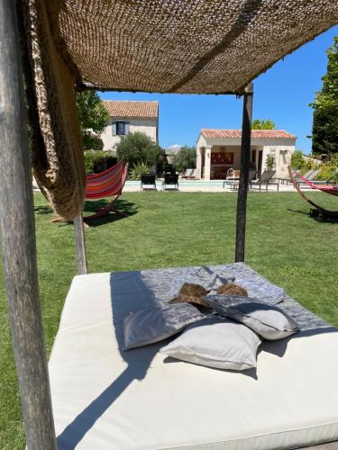 a bed with a net canopy in a yard at Le Mas Saint Philippe in Jonquières