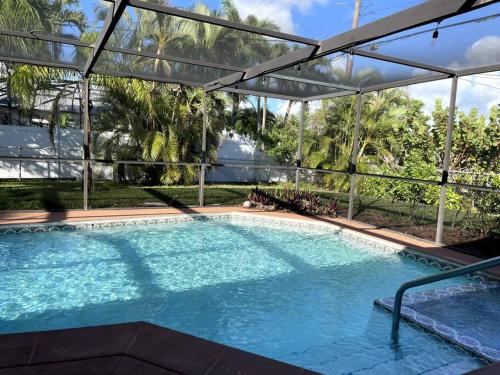 a large swimming pool with a pergola at The Flip Flop - UPDATED vacation home! in Naples