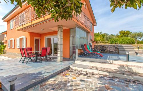 a patio with chairs and a table in front of a house at Cozy Apartment In Koper With Sauna in Koper