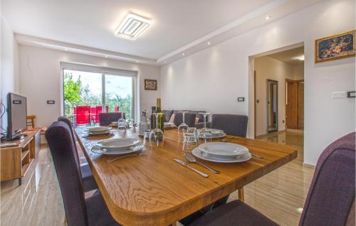 a dining room with a wooden table and chairs at Cozy Apartment In Koper With Sauna in Koper