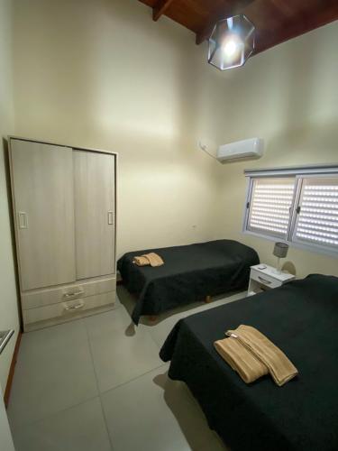 a bedroom with two beds and a large mirror at Pinares del Norte in Federación