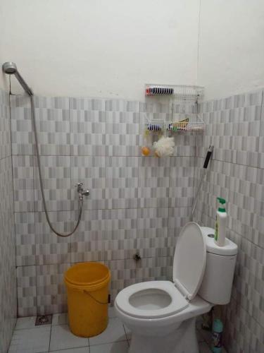 a bathroom with a toilet and a shower at BRAVILIA GUEST HOUSE in Sorong