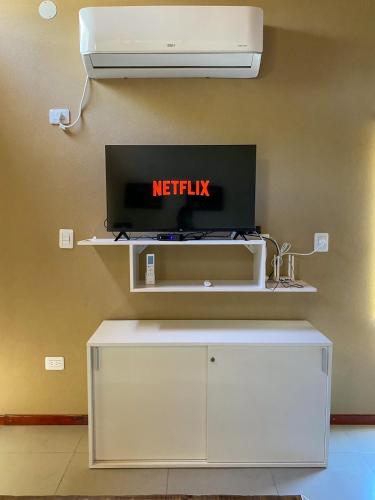 a tv on a wall with a netflix sign on it at Pinares del Norte in Federación
