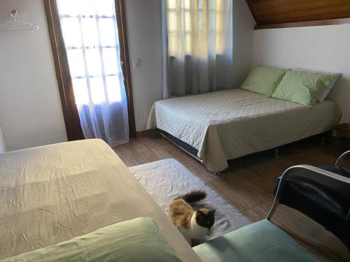 Postel nebo postele na pokoji v ubytování Chalés Búzios