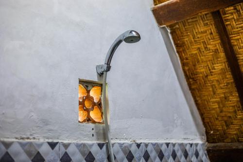 a shower with three hot dogs in a box at Diamond Beach Bungalow in Nusa Penida