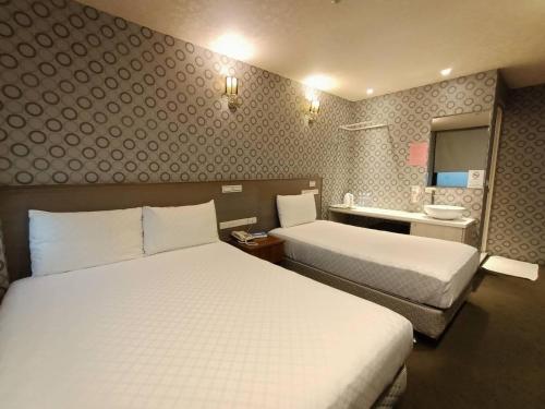Postel nebo postele na pokoji v ubytování Taiwan Seven Days Boutique Hotel