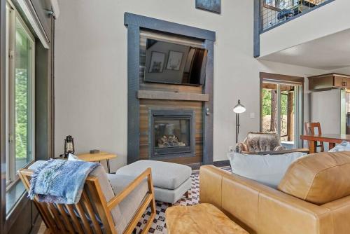 a living room with a couch and a fireplace at High Mountain Rustic Cabin Hot Tub Game Loft in Lead