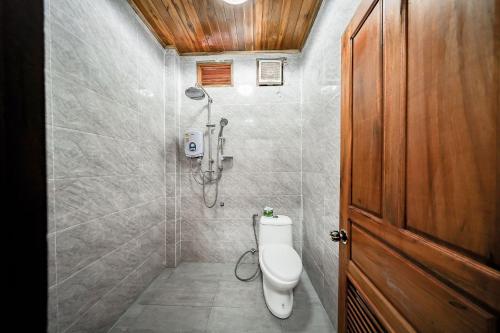 a bathroom with a toilet and a shower at Villa Wanika in Luang Prabang