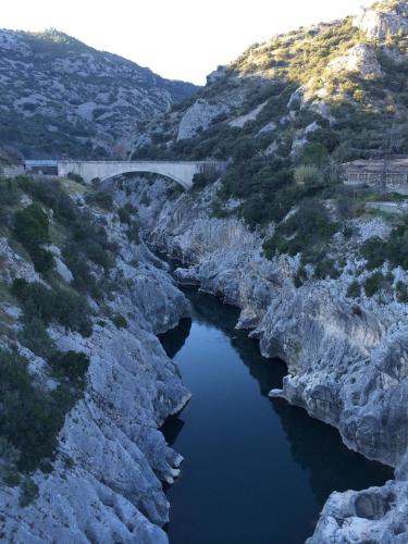 a bridge over a river in a canyon at Hôtel Le Gambetta in Vias