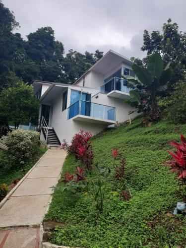 a house on top of a hill with a pathway at Finca Pozo Azul in La Vega
