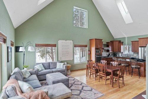 a living room with a couch and a table at Leightons Lodge Hot Tub Borders National Forest in Hill City