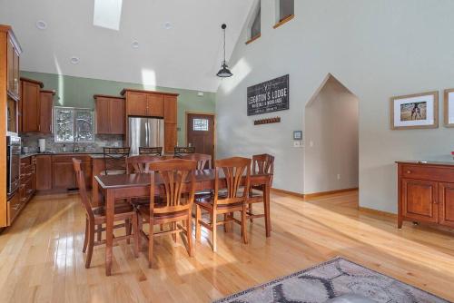 a kitchen and dining room with a table and chairs at Leightons Lodge Hot Tub Borders National Forest in Hill City