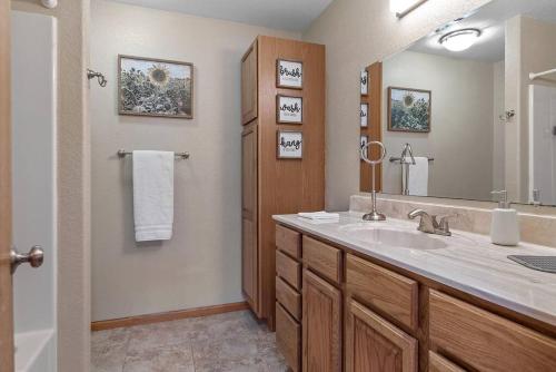 a bathroom with a sink and a large mirror at Leightons Lodge Hot Tub Borders National Forest in Hill City
