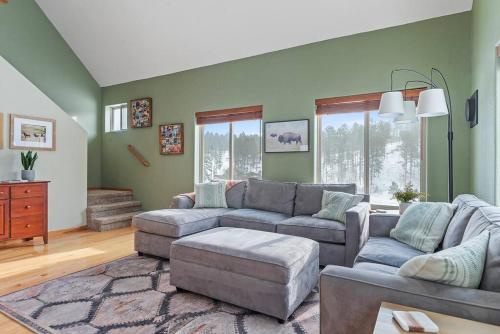 a living room with a couch and a table at Leightons Lodge Hot Tub Borders National Forest in Hill City