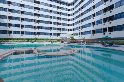 a large swimming pool in front of a large building at Asia Airport Hotel in Bangkok