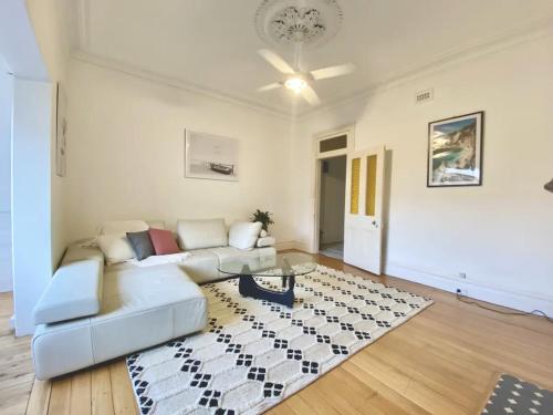 a living room with a couch and a table at Sunny Apartment in Surry Hills in Sydney
