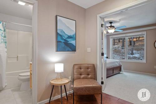 a bedroom with a bed and a chair and a table at Elk Ridge Fire Place Custer in Custer