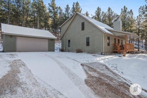 a house in the snow with a driveway at Elk Ridge Fire Place Custer in Custer