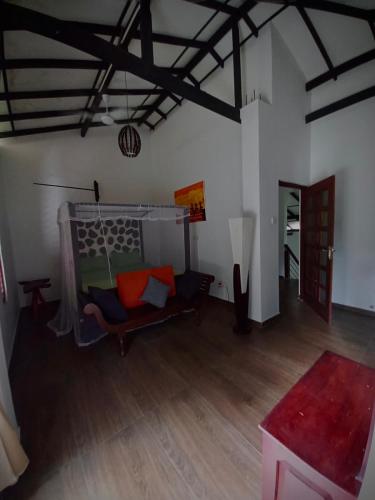 a living room with a couch and a wooden floor at Luxury villa Costanza in Hikkaduwa
