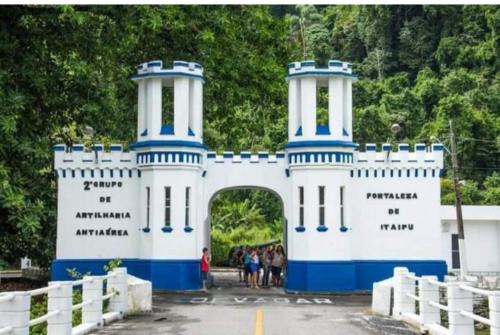 a group of people standing in front of a white and blue bridge at Praia grande canto do forte top in Praia Grande