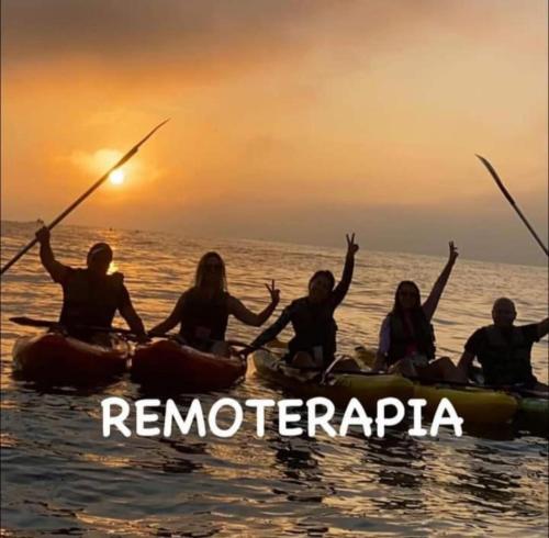 a group of people on kayaks in the water at Praia grande canto do forte top in Praia Grande
