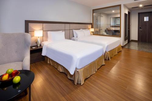 Giường trong phòng chung tại ASTON Nha Trang City Hotel