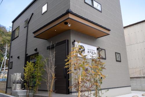 um edifício com uma porta preta com um sinal em Second Home 瀬戸風月 em Takamatsu