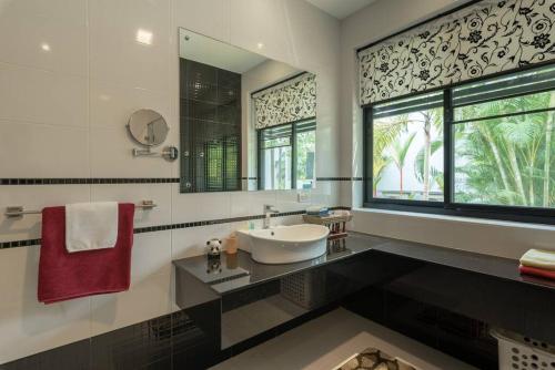 a bathroom with a sink and a large window at Countryside Villa, 2 Bedroom Villa, Infinity Pool and maid service in Chiang Mai